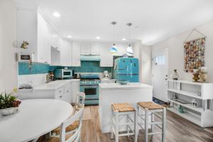 a kitchen with white cabinets and blue appliances at 359SA 359 Sumner A in Avalon