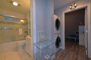 a bathroom with a washer and dryer in it at 359SC 359 Sumner C in Avalon +4 photos