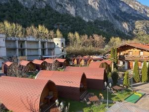 a group of buildings with a mountain in the background at Inn-side ADVENTURE CABINS in Haiming