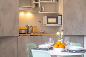 a kitchen with a table with fruit on it at L'Arancio e i Pesci Rossi in Calatabiano
