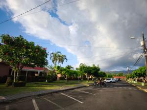 a street with people riding bikes on the road at Villa Coco - Jaco Beach in Jacó