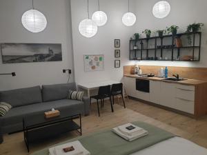 a living room with a couch and a kitchen at Pribina Penzión in Nitra