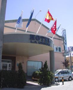 a hotel with flags on top of a building at Hotel La Union in Humanes de Madrid