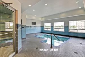 a large bathroom with a swimming pool and a shower at Canalta Hotel Lac La Biche in Lac La Biche
