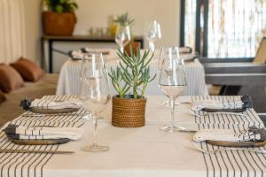 a table with wine glasses and napkins on it at Casa Bonita Hotel & Luxury Residence in Oaxaca City