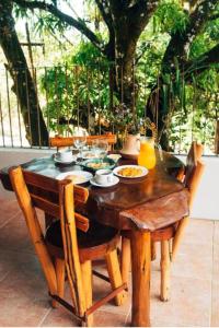 a wooden table with plates of food on it at Flat 305 hotel Fazenda Engenho Pedra do Rodeadouro in Bonito