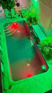 a swimming pool with a red ball in the water at Habitaciones villa oti in Ciénaga
