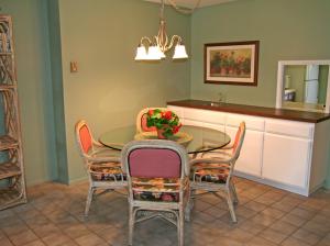 a dining room with a glass table and chairs at Bahia Vista A11 in Avalon