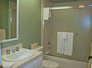 a bathroom with a sink and a shower with towels at Bahia Vista A11 in Avalon