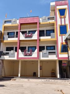 un condominio di colore rosa e giallo di Shree Dev Kripa Geust house a Ujjain