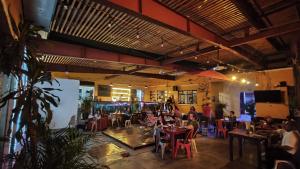 a group of people sitting at tables in a restaurant at Iguana Coliving in Oaxaca City