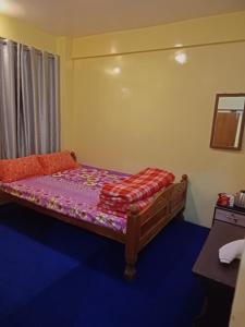 a small bedroom with a bed with a purple mattress at Lemon Tree Homestay Prime Location in Darjeeling