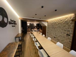 a dining room with wooden tables and white chairs at CASA MERCEDES-PUERTOMINGALVO in Puertomingalvo