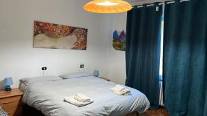 a bedroom with a bed with towels on it at Appartamento luce in Fanano