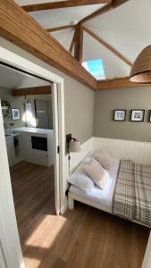 a bedroom with a bed in a room with a ceiling at Cosy Luxury Cotswold Retreat in Gretton