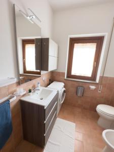 a bathroom with a sink and a toilet and a mirror at Residenza Lucia in Campagnano di Roma +37 photos