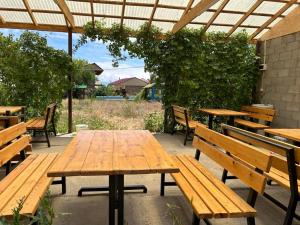 a wooden table and benches in a patio at Moonlight in Cholpon-Ata