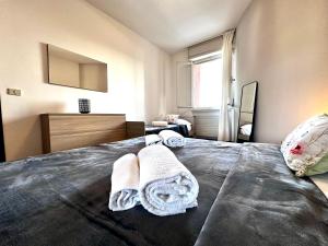 a bedroom with a bed with towels on it at Blue wave apartment by the sea in Lignano Sabbiadoro