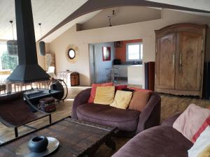a living room with two couches and a stove at Villa Seychelles in Nieul-sur-Mer