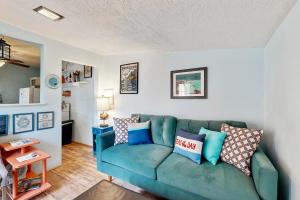 a living room with a blue couch in a room at Happy Crabby Shack in Rockaway Beach