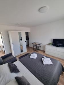 a bedroom with a bed with two towels on it at Studio Apartment Petra Umag in Umag