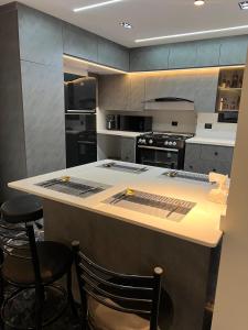 亚历山大Private Room in shared apartment with Sea View Balcony的厨房配有柜台和一些椅子