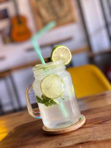 a mason jar filled with a drink with a slice of lime at Bel appartement familial au centre ville in El Kelaa des Srarhna +10 photos