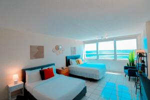 A bed or beds in a room at Castle 1733 Ocean view studio with direct beach access, pool, tennis & free parking