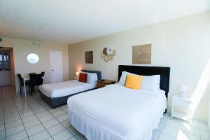 A bed or beds in a room at Castle 1733 Ocean view studio with direct beach access, pool, tennis & free parking