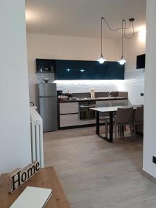 a kitchen and dining room with a table and refrigerator at La casa di Susy - Casa Vacanze in Viterbo