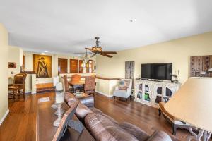 a living room with a couch and a tv at H153 - Hamilton Cove Villa 1-53 in Avalon
