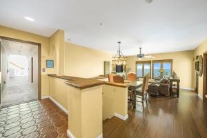 a living room and dining room with a kitchen and dining table at H153 - Hamilton Cove Villa 1-53 in Avalon
