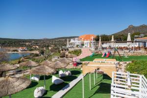 a view of a resort with chairs and umbrellas at Poseidon Apartments and Villas by the Sea in Sounio