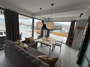 a living room with a couch and a table at Balandda Chimgan in Chimgan