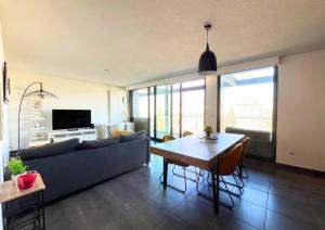 a living room with a couch and a table at Appartement Vue Canal in Strasbourg