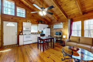 a kitchen and a living room with a ceiling fan at Country Cottage in Sautee Nacoochee +34 photos
