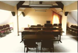 a room with tables and chairs in a building at Mont Blanc in Predeal