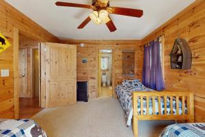 a bedroom with two beds and a ceiling fan at Bears Cove in Sautee Nacoochee