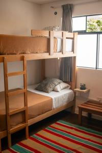 Ένα ή περισσότερα κρεβάτια σε δωμάτιο στο Temazcal Hostel