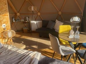 a living room with a table and a couch at Dôme Bel'Etoile in Bellencombre