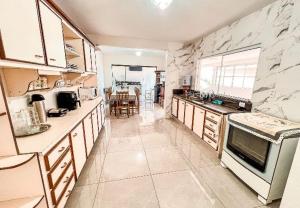 a large kitchen with marble walls and a counter top at Casa in Monte Sião