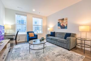 a living room with a couch and a table at Modern Apt with Rooftop and Pool in Prospectville +11 photos