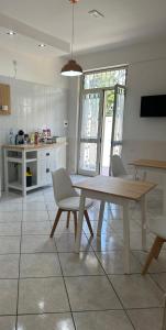 a kitchen with a wooden table and chairs at In famiglia rooms for Pompei, Amalfi, Sorrento, Napoli e Salerno in Sant'Egidio del Monte Albino