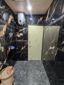 a bathroom with a toilet and a door in it at CharDara Agrotourism & FarmStay in Mahabaleshwar
