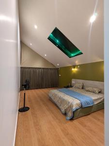 a bedroom with a bed with a green ceiling at CharDara Agrotourism & FarmStay in Mahabaleshwar