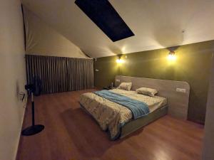 a bedroom with a bed in a room at CharDara Agrotourism & FarmStay in Mahabaleshwar