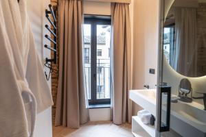 a bathroom with a sink and a mirror and a window at Las Amiras Homes Collection in Granada +79 photos
