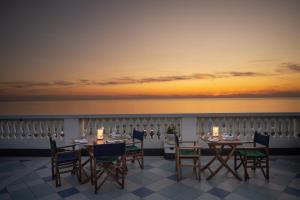 a table and chairs on a balcony with the ocean at Palace Hotel in Viareggio