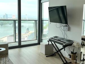 a computer keyboard and monitor on a stand in a living room at Luxury aparment in Eurovea Tower in Bratislava