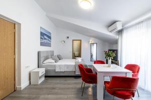 a bedroom with a bed and a table and chairs at Villa Valamare in Podstrana